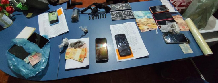 Arma, drogas, dinheiro e celulares apreendidos na operação.
