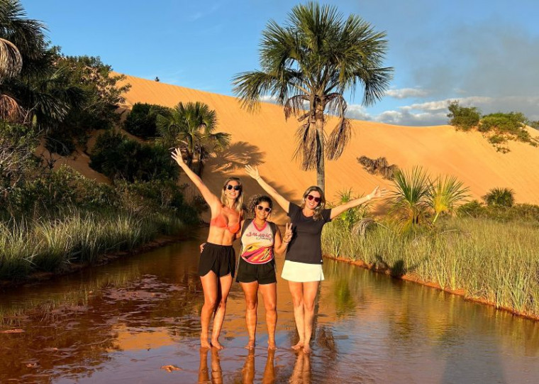 Fernanda com duas clientes nas dunas: maioria das viajantes têm nível superior e mais de 30 anos